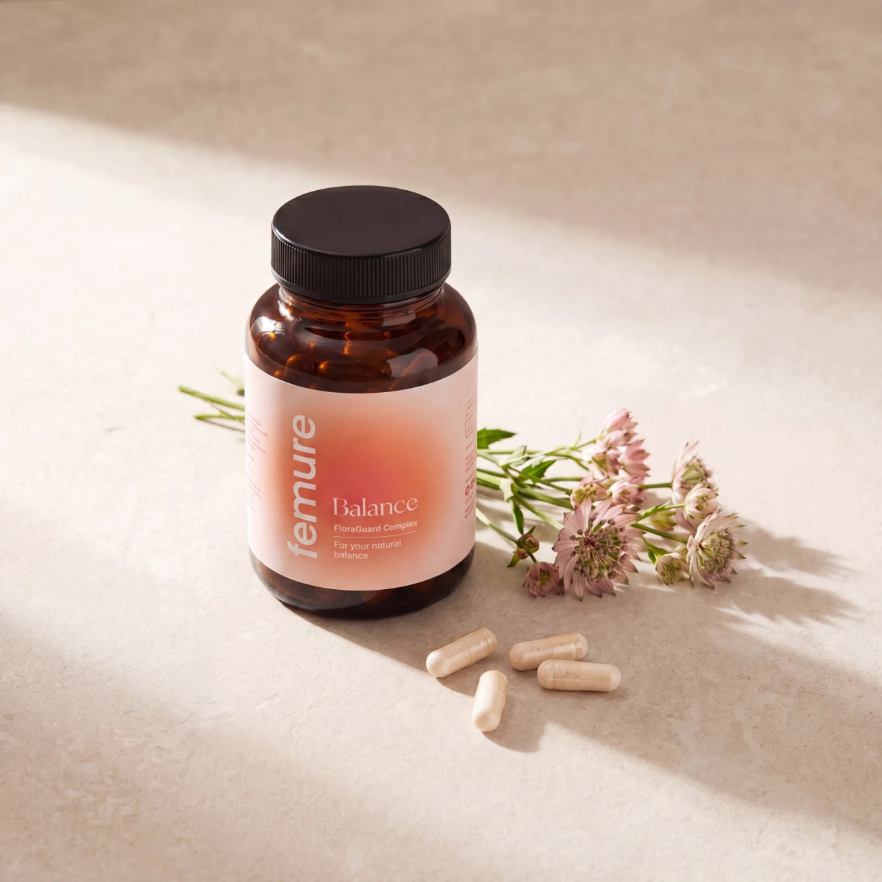 femure BALANCE bottle with capsules and flowers